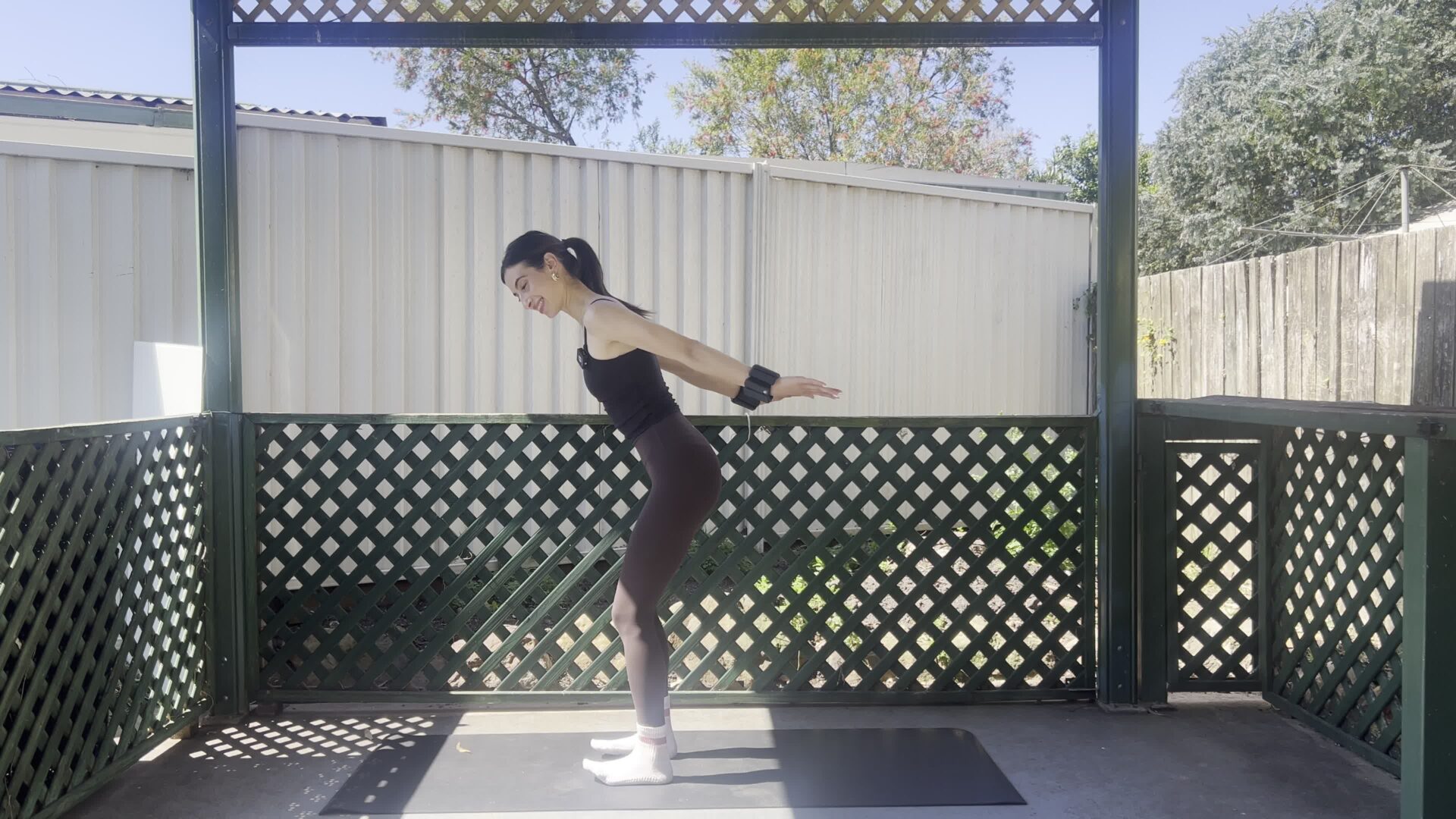 woman doing daily pilates routine at home on a yoga mat building strength and consistency