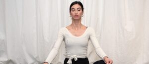 Woman practicing Pilates breathwork on a yoga mat to strengthen core and improve focus