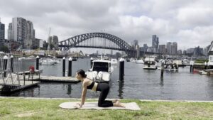 A woman doing a core-focused Pilates mat workout from home as part of her Pilates membership.
