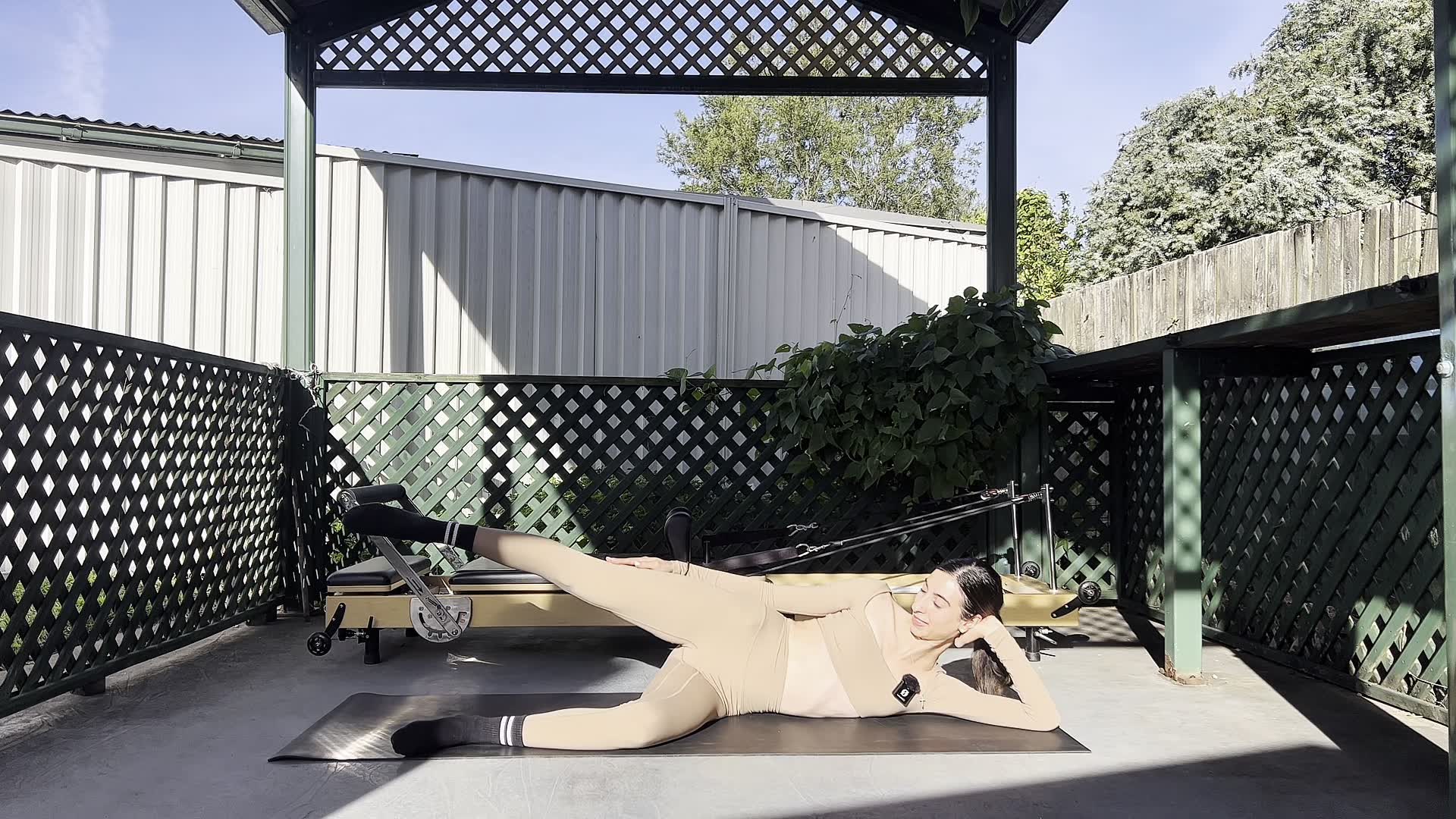 woman practising Pilates for bad posture and spinal alignment at home on a yoga mat