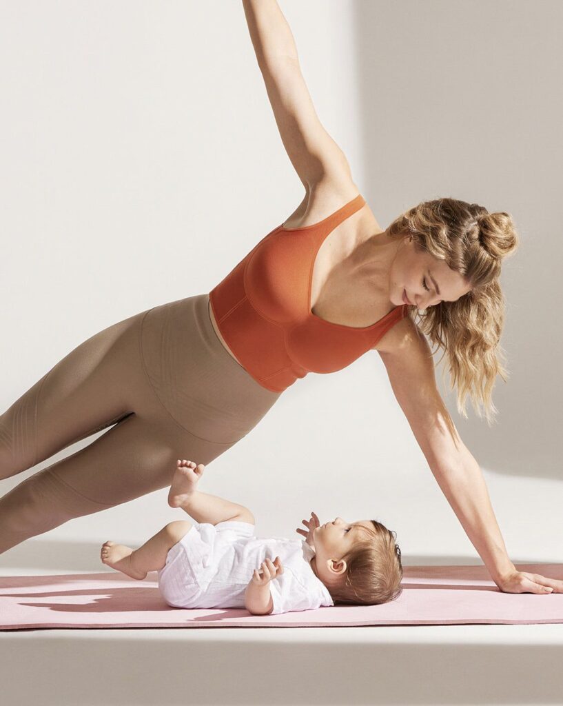 mum doing online pilates for mums at home on yoga mat