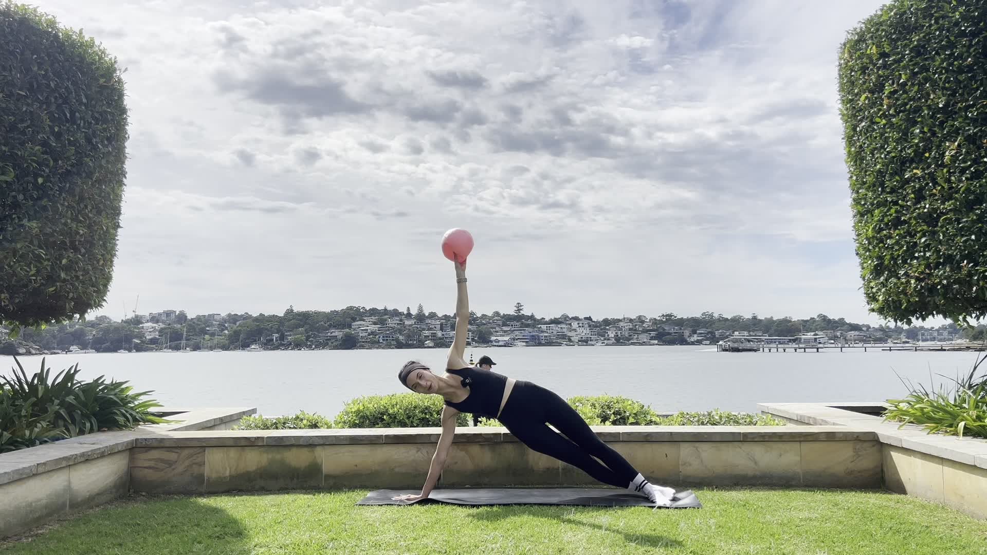 woman doing pilates for beginners at home on a yoga mat in her living room feeling calm and strong